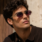 Miu Miu Oval Gold Sunglasses (SMU B51) worn by a model